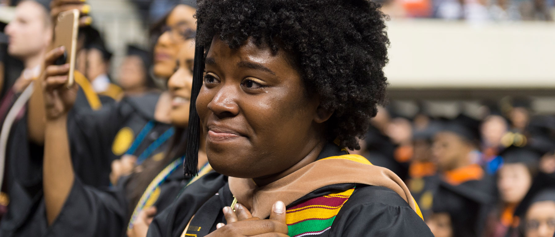 an emotional student graduate attending her commencement ceremony at v.c.u.