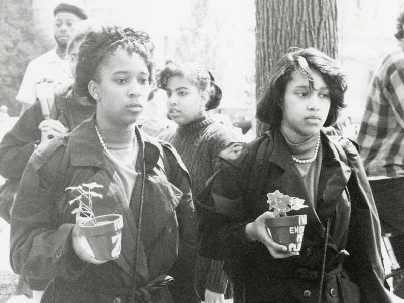 v.c.u. members of a sorority from 1980s carrying potted plants