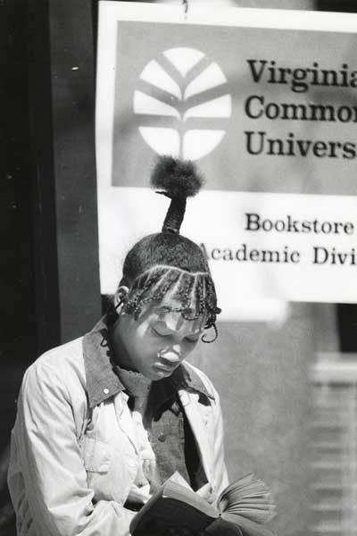 a student reads intently in front of the v.c.u. bookstore in the 1980s