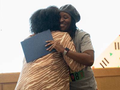 Dr. Grace Gipson hugs a student who has received an award