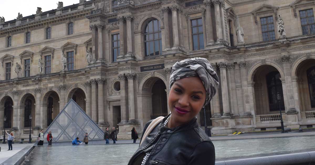 v.c.u. student posing in front of the denon pavillion in paris