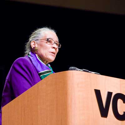 njeri jackson speaking behind a v.c.u. podium