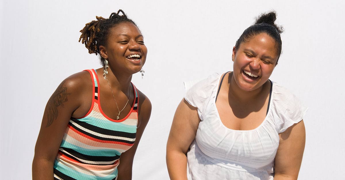 Two friends laughing together.