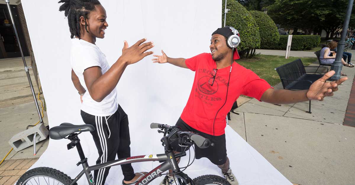 two happy v.c.u. students greet each other affectionately