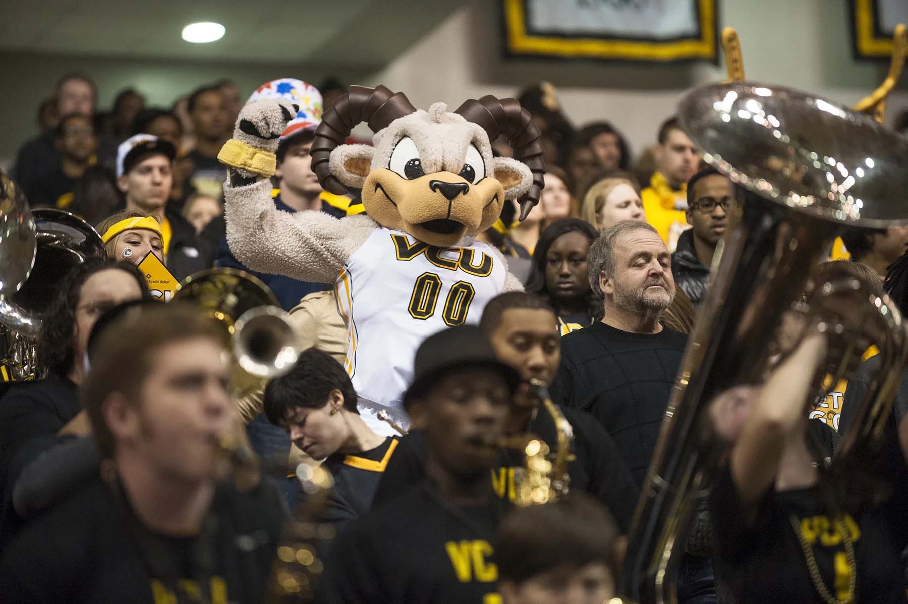 v.c.u.'s mascot rodney the ram cheering while a pep band surrounding him plays instruments